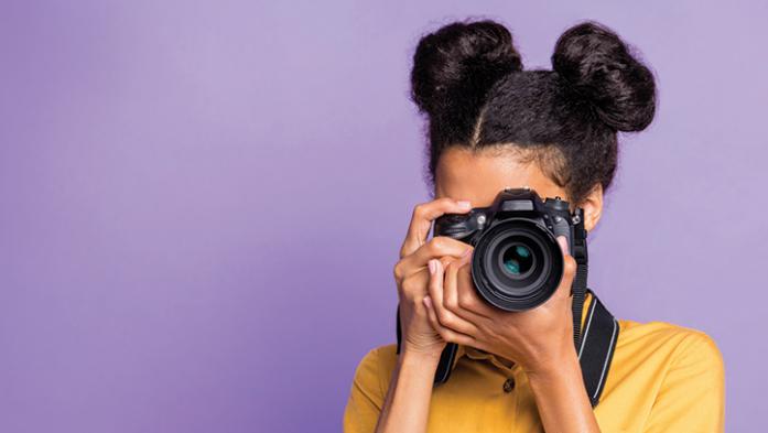 photo of young female photographer on a purple background 