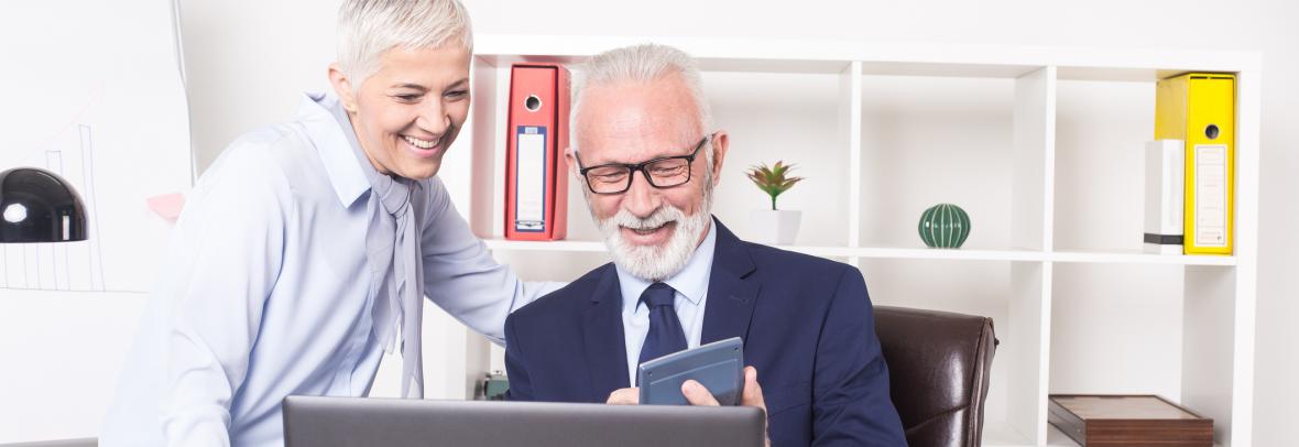 Photo of mature couple using a calculator