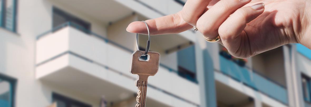 Real estate agent holding keys to new condo