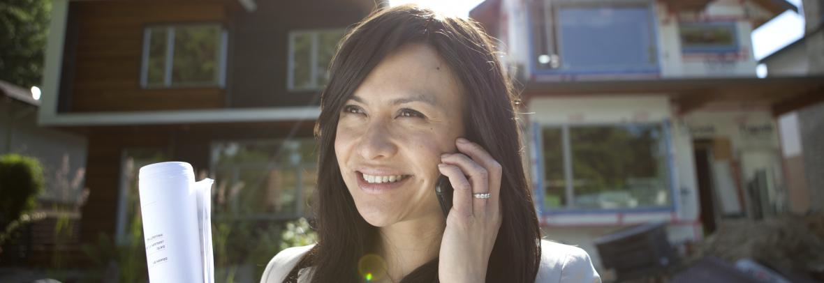 realtor on phone outside a house