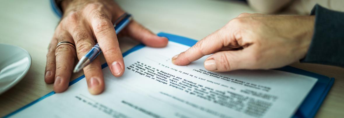 closeup of hands filling out paperwork