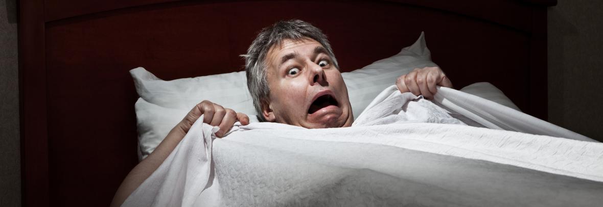 Scared man in bed