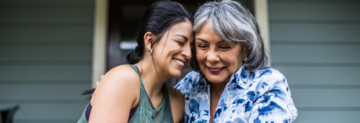 young woman and older woman hugging