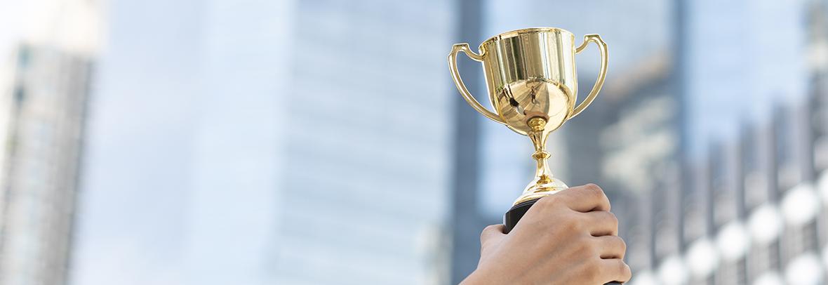 Photo of a person holding a trophy