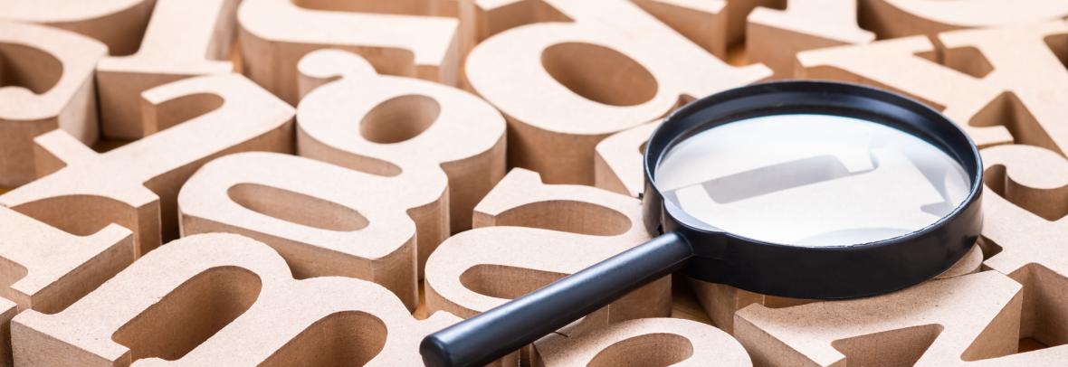 magnifying glass with wooden letters