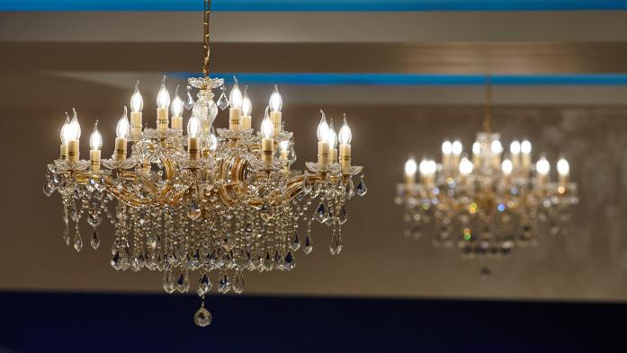 A large crystal chandelier with lights on
